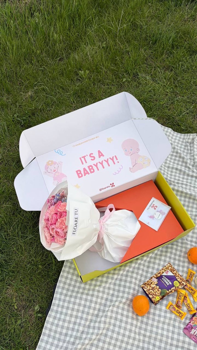 Gift box with flowers, chocolates and treats